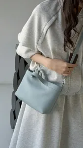 Minimalist leather shoulder bag for women, stylish light blue casual daily crossbody tote.