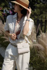 Elegant genuine cowhide leather top-handle bag in light beige for women, stylish and compact.