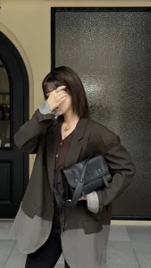 Black cowhide leather messenger bag, casual crossbody shoulder bag for women daily commute.