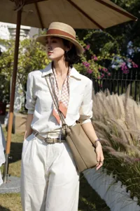 Genuine leather bucket bag for women, large capacity shoulder commuting bag with stylish design.