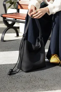 Genuine leather bucket bag for women, large capacity casual hobo shoulder bag commuting style.