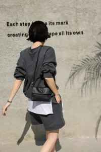 Black genuine cowhide leather handbag, stylish mini shoulder bag for spring summer commute.