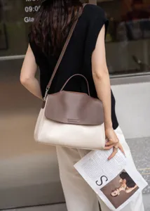 Close-up detail of the stylish two-tone leather handbag showing soft texture and premium stitching.