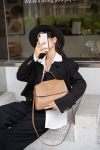 Soft leather shoulder tote bag for women, stylish commuting handbag with large capacity and strap.