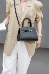 Classic black leather top handle crossbody bag for women, stylish daily commute purse.