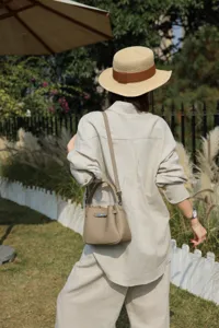 Close-up detail of mini leather bucket bag with crossbody strap for casual daily wear.