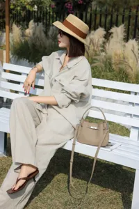 Mini cowhide leather bucket bag detail view showing elegant design and versatile daily style.