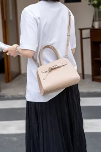 Chic leather shoulder bag for women, stylish commuting crossbody handbag with top handle.