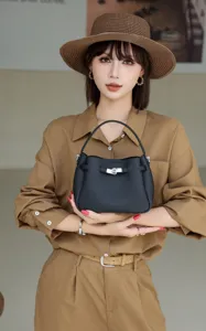 Stylish mini genuine leather bucket bag, chic handbag with metal lock design for women.
