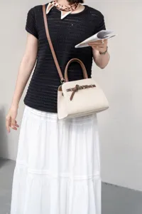 Genuine leather women handbag detail view, minimalist commuter crossbody shoulder bag.