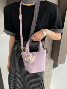 Stylish leather bucket bag for women, luxury niche design with cute pendant, shoulder bag.