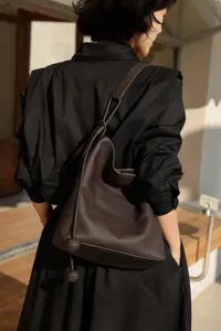 Close-up detail of the dark brown genuine leather hobo shoulder bag with stylish knotted strap.