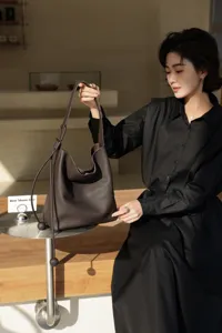Genuine leather shoulder bucket bag for women, large capacity commuter hobo bag in dark brown.