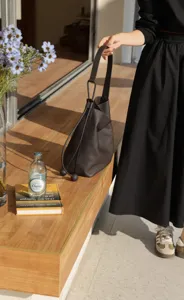 Elegant dark brown leather bucket bag for women, large capacity commuter shoulder and underarm bag.