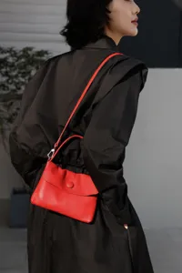 Red genuine leather shoulder bag for women, stylish button closure mini handbag for daily commute.