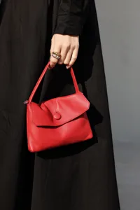 Genuine leather button handbag for women, stylish spring summer mini red tote bag for commuting.