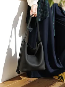 Genuine leather bucket bag for women, large capacity commuter shoulder bag, casual luxury chic.