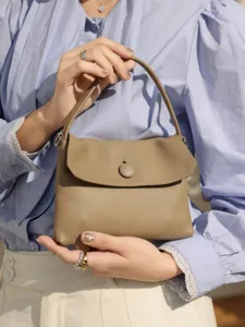 Premium genuine leather top-handle bag, chic button closure handbag for women commute.