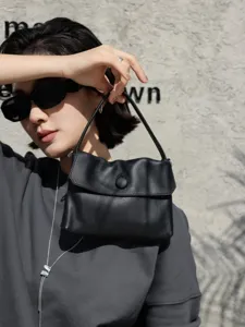 Black genuine leather top handle handbag with chic button closure, stylish daily tote bag.