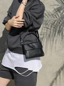Black leather top-handle crossbody bag for women, stylish minimalist commuter handbag.