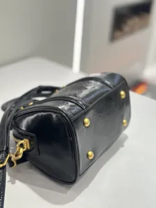 Detailed view of the black oil-wax leather vintage Boston handbag bottom and hardware.