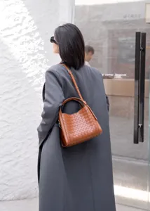 Brown leather woven crossbody bag, stylish women's shoulder bag with top handle for daily use.
