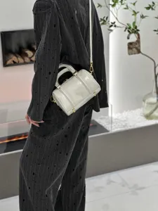 Detail view of retro oil-waxed genuine leather Boston handbag with metal hardware.