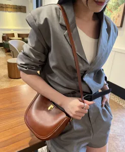 Premium leather saddle bag for women, vintage brown crossbody shoulder bag with metal lock.