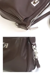 Brown leather shoulder bag detail, showing premium texture, silver hardware and lock.
