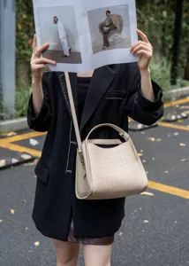 Detailed view of beige woven leather shoulder crossbody basket bag, casual fashion style.