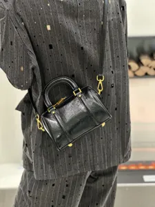 Black oil wax genuine leather vintage boston handbag with gold hardware for women details.