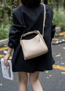 Detailed view of women woven leather shoulder crossbody bag featuring a stylish basket design.