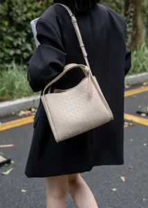 Detail shot of the beige woven leather shoulder bag showcasing exquisite craftsmanship.
