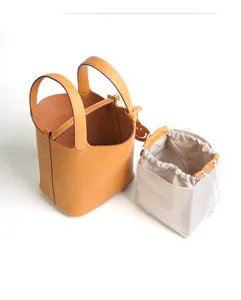 Genuine leather bucket handbag with inner pouch, stylish orange top-handle bag for daily use.