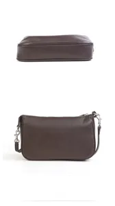 Brown leather underarm bag detail showing zipper closure, refined stitching, and metal rings.