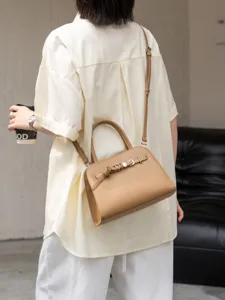 Classic leather shoulder bag for women, stylish commuting crossbody handbag with top handles.