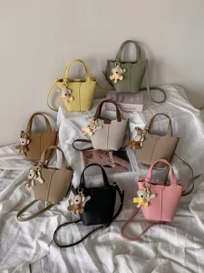Genuine leather bucket bag with cute bear charm, multi-color stylish shoulder crossbody bag.