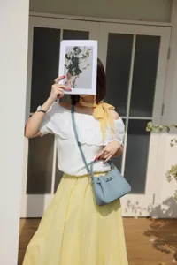Mini cowhide leather bucket handbag crossbody bag with classic design for women casual use.