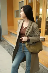 Detailed view of the retro green leather hobo dumpling shoulder bag in urban scene.
