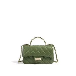 Grüne gesteppte Lederhandtasche Detailansicht mit Metallkette und klassischem Drehverschluss.