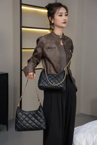 Detailed view of women genuine leather quilted underarm shoulder bag with chain strap fashion accessory.
