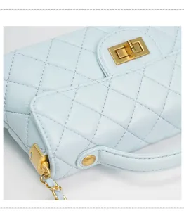 Light blue quilted small square handbag with gold turn lock and chain strap for women.