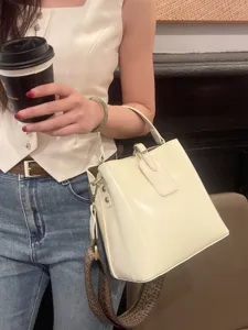 Stylish white leather bucket bag for women, versatile large capacity shoulder and crossbody bag.