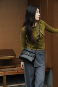 Detail view of women's black genuine leather retro shoulder crossbody bag for daily commute.