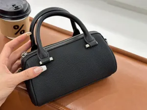 Black genuine leather Boston handbag, chic pillow crossbody bag with top handles and silver hardware.