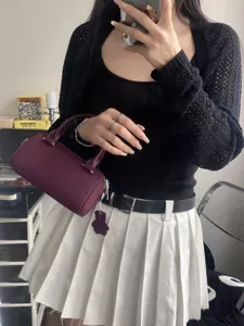 Compact leather boston handbag with cute bear charm, stylish crossbody bag for daily wear.