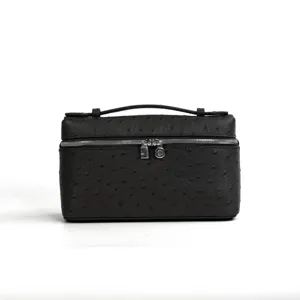 Black ostrich pattern leather handbag vanity box with top handle and silver hardware.