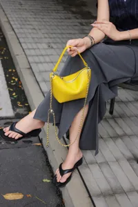 Genuine leather mini shoulder bag for women, stylish yellow crossbody bag with chain strap.