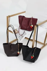 Genuine leather tote bag for women, large capacity shoulder bucket bag with cute charm.
