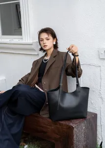 Premium genuine leather black tote bag for women, large capacity shoulder commuting bag.